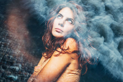 Double exposure of thoughtful woman and waves