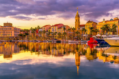 Christmas illuminated port of sanary sur mer in south of france reflected to mediterranean at sunset