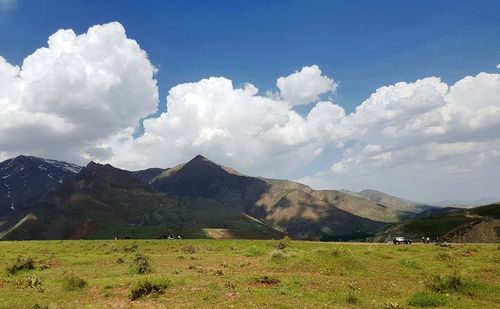 Scenic view of landscape and mountains against sky