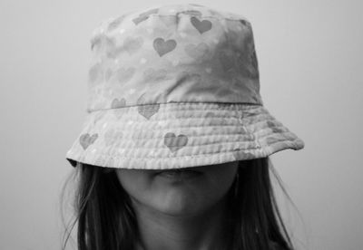 Close-up of girl against white background