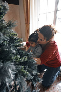 Rear view of mother and son on tree