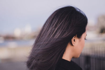 Close-up of woman standing against sky