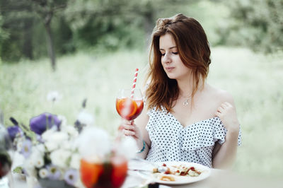 Beautiful woman sitting on table