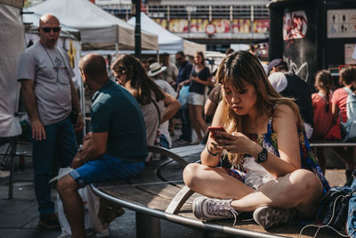 Group of people looking at market in city