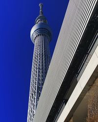 Low angle view of modern building against clear blue sky