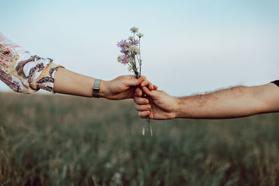 Man giving flowers to a woman