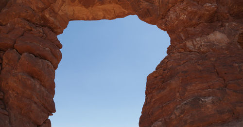 Low angle view of rock formation against clear sky