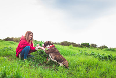 Woman with dog on field