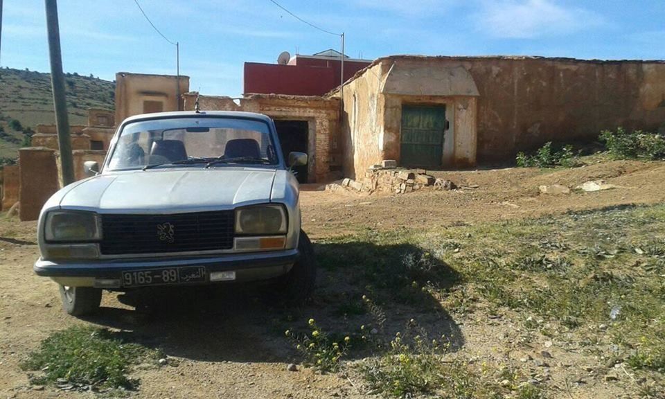 ABANDONED CAR ON ROAD BY LAND