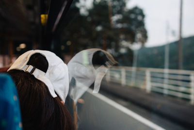 Woman wearing cap while traveling in vehicle