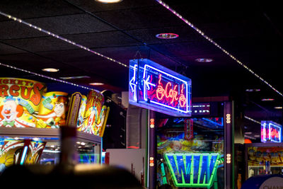 Low angle view of illuminated neon sign at night