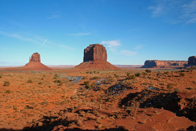 Rock formations in desert against blue sky