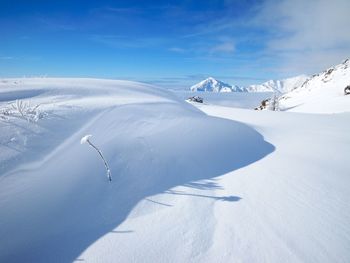 Aerial view of snowcapped mountain against sky