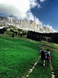 Scenic view of grassy field against cloudy sky