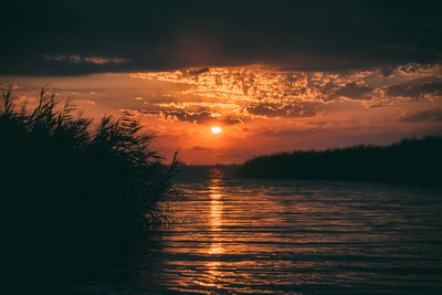 Scenic view of sea against romantic sky at sunset