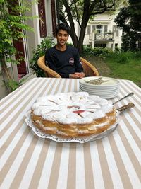 Portrait of smiling man against cake