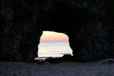 Scenic view of sea seen through arch