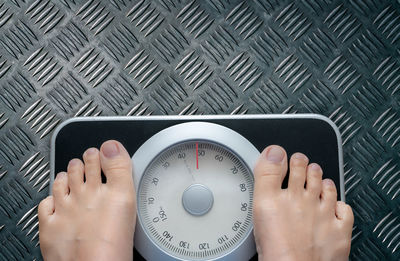 Top view of feet on weighing scale. women weigh on a weight balance scale after diet control. 