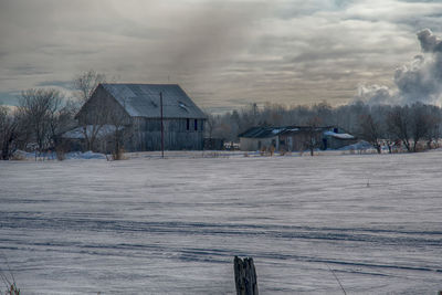 Barn in winter with trees