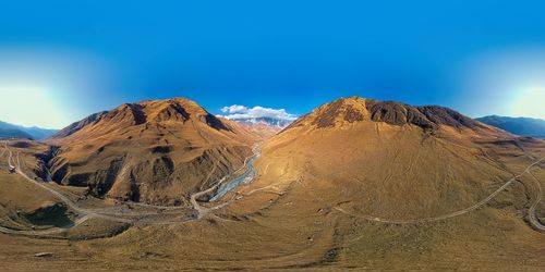 Scenic view of arid landscape against sky