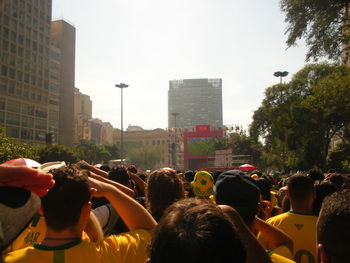 People on street against buildings in city