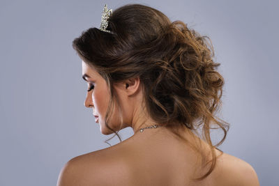 Rear view of bride against gray background