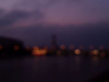 Defocused image of illuminated city at night