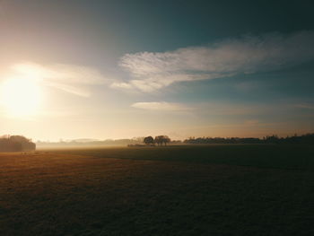 Scenic view of field against sky during sunset