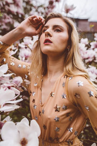 Portrait of beautiful woman with pink flowers