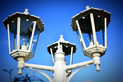 Low angle view of street light against clear blue sky