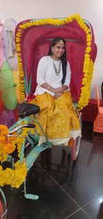 Portrait of smiling woman siting on a tricycle