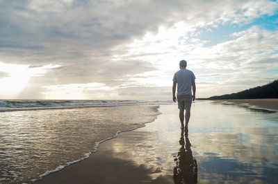 Rear view of man standing on beach