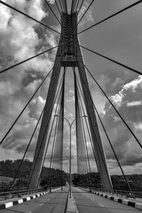 View of suspension bridge against cloudy sky