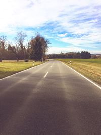 Road by trees against sky