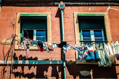 Low angle view of clothes drying outside building