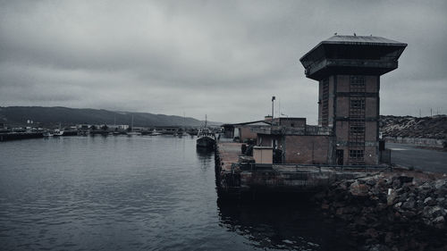 Scenic view of sea by buildings against sky