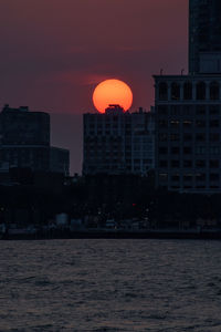 Buildings in city at sunset