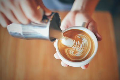 Midsection of woman holding coffee cup