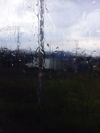 Close-up of wet glass window in rainy season