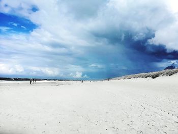 Scenic view of beach against sky during winter