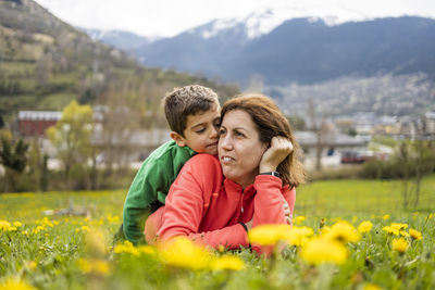 Mother and son on mountain against plants