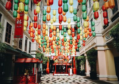 Low angle view of lanterns hanging by building