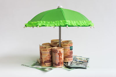 Close-up of coins in container against white background