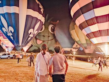 Rear view of people watching hot air balloons