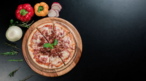 High angle view of pizza on table against black background