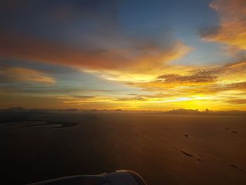 Scenic view of beach against sky during sunset