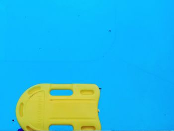 Close-up of yellow swimming pool against clear blue sky