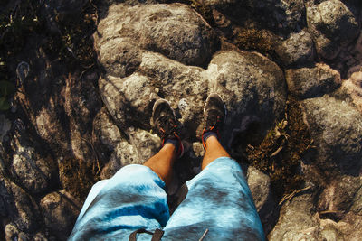 Low section of person standing on rock