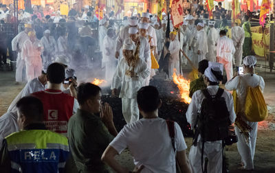 Rear view of people standing outside temple