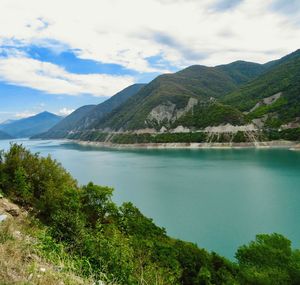 Scenic view of lake and mountains against sky